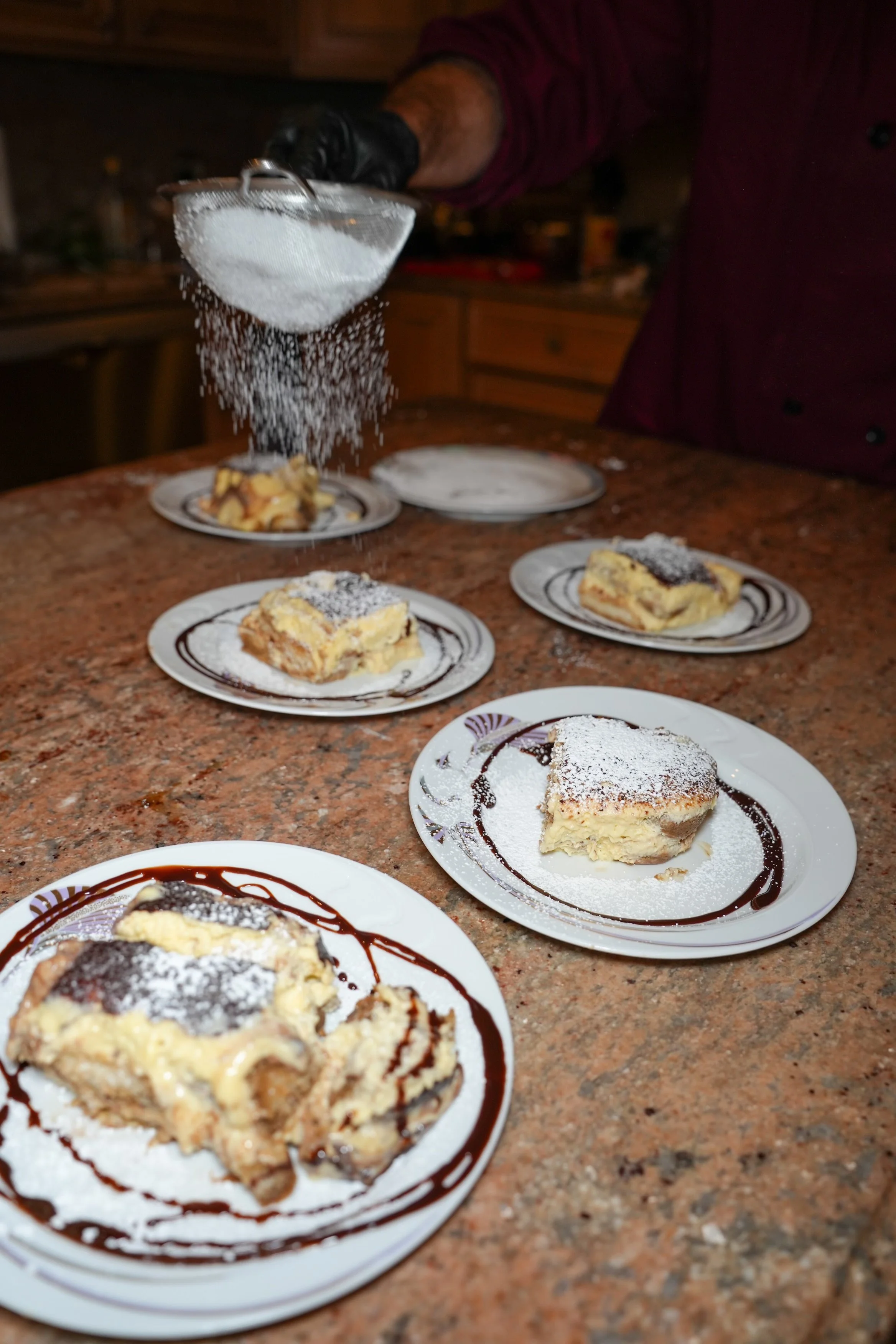 Desserts being prepared with powdered sugar