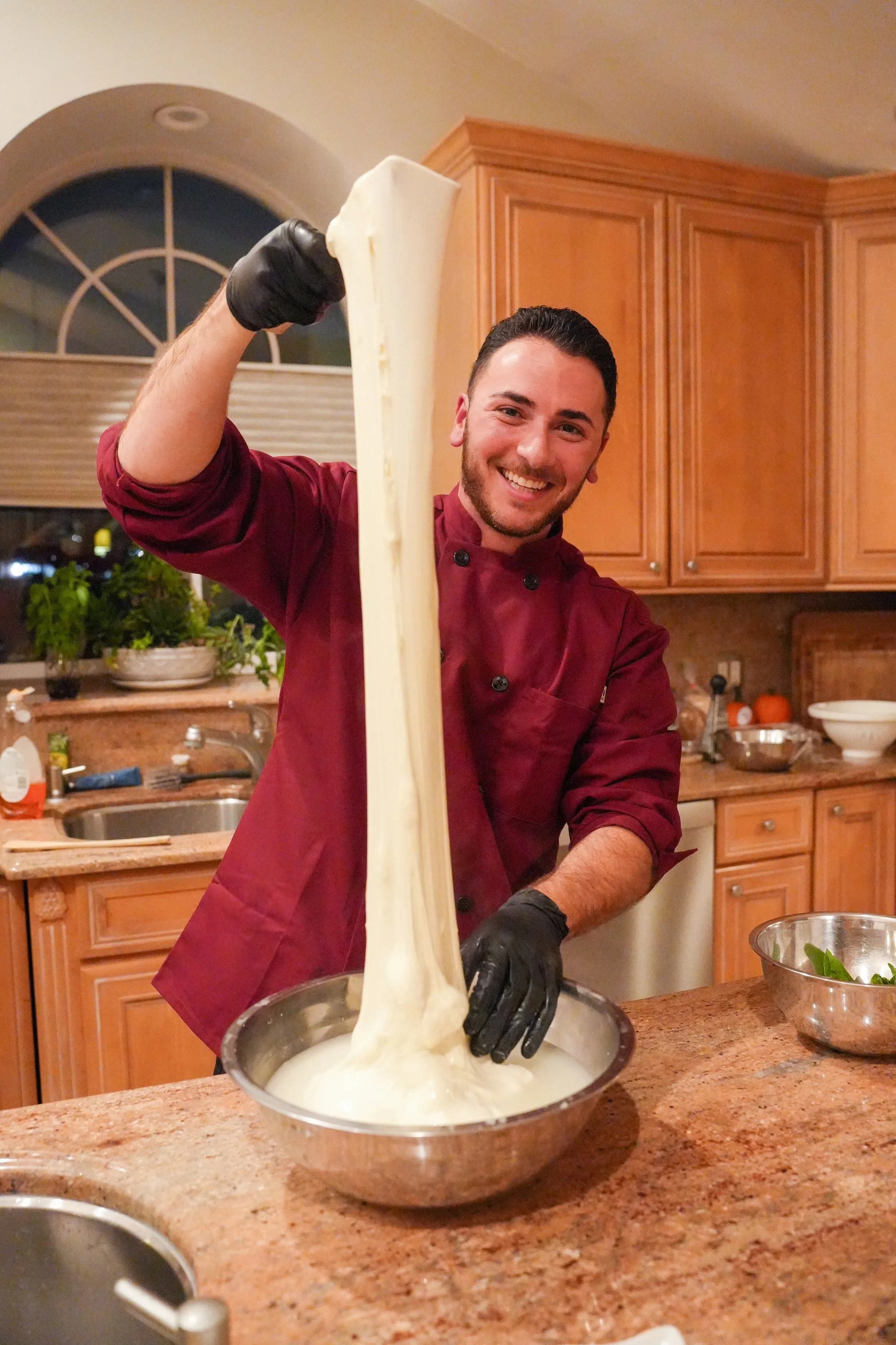 Chef Chris stretching mozzarella