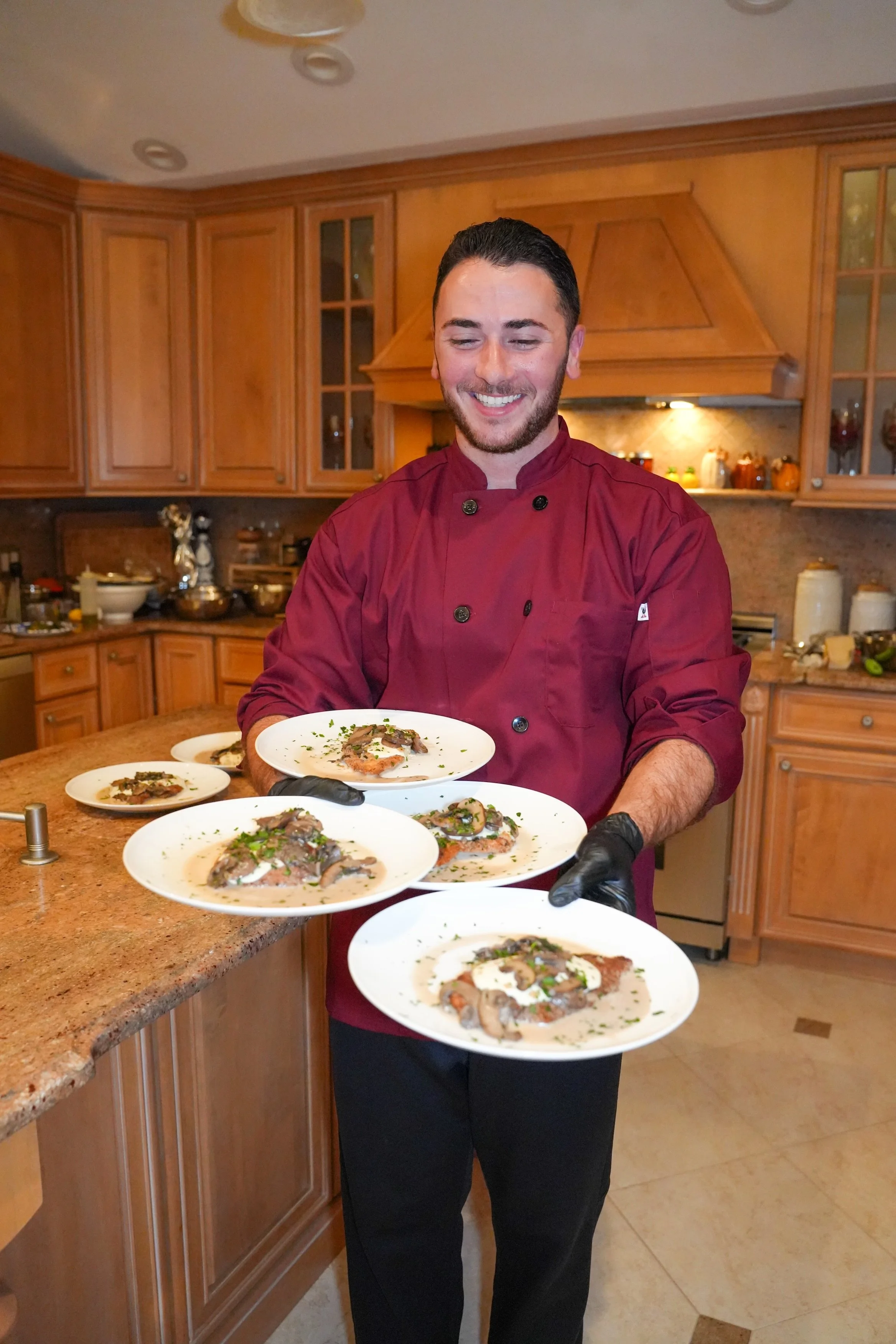 Chef Chris with delicious plates of veal valdostano